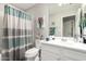 Bathroom featuring a shower-tub combo with white vanity and decorative accents at 28931 N 64Th Dr, Phoenix, AZ 85083