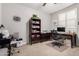 Bright room featuring a desk, bookcase, and a window with white shutters, perfect for a home office at 28931 N 64Th Dr, Phoenix, AZ 85083