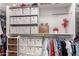 Organized walk-in closet with shelving and hanging rods for storage at 28931 N 64Th Dr, Phoenix, AZ 85083