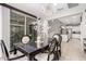 Open-concept dining area with modern chandelier, complemented by sliding glass doors and seamless access to kitchen at 28931 N 64Th Dr, Phoenix, AZ 85083