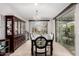 Elegant dining room featuring stylish chandelier, large sliding glass doors and classic china cabinet for refined living at 28931 N 64Th Dr, Phoenix, AZ 85083
