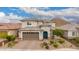 Beautiful two-story home with desert landscaping, brick driveway, brown garage door, and mountain views at 28931 N 64Th Dr, Phoenix, AZ 85083