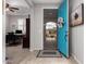 Inviting entryway featuring a vibrant blue door, opening into a view of an office and the front walkway at 28931 N 64Th Dr, Phoenix, AZ 85083