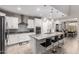 Bright open kitchen with large island, white cabinetry, modern appliances, and adjacent dining area at 28931 N 64Th Dr, Phoenix, AZ 85083