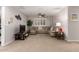 Cozy living room with a comfortable sectional sofa, a ceiling fan, and a large window providing ample natural light at 28931 N 64Th Dr, Phoenix, AZ 85083