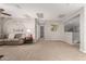 Upstairs loft featuring a large seating area, neutral paint and carpet, and a view overlooking the downstairs at 28931 N 64Th Dr, Phoenix, AZ 85083