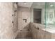 Shower with glass enclosure, tile surround, and bench seating at 28931 N 64Th Dr, Phoenix, AZ 85083