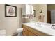 Bathroom featuring a wooden vanity, decorative mirror, and framed desert artwork at 2929 W Yorkshire Dr # 1066, Phoenix, AZ 85027