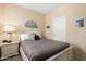 Cozy bedroom featuring comfortable furnishings and nautical themed art at 2929 W Yorkshire Dr # 1066, Phoenix, AZ 85027