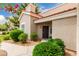 Inviting entrance to a home featuring a walkway, desert landscaping, and a dark wood front door at 2929 W Yorkshire Dr # 1066, Phoenix, AZ 85027