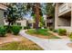 The landscaped grounds show sidewalks, lush green grass, a variety of trees and beautiful plants to enhance community appeal at 2929 W Yorkshire Dr # 1066, Phoenix, AZ 85027