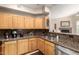 Bright kitchen with light wood cabinets, granite countertops, and stainless steel appliances at 2929 W Yorkshire Dr # 1066, Phoenix, AZ 85027