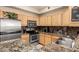 Well-lit kitchen with stainless steel appliances, wooden cabinetry, and granite countertops at 2929 W Yorkshire Dr # 1066, Phoenix, AZ 85027
