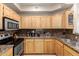 Well lit kitchen with light wood cabinets, stainless steel appliances, and granite countertops at 2929 W Yorkshire Dr # 1066, Phoenix, AZ 85027