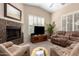 Comfortable living room features a fireplace, carpeted floors, and tan upholstered reclining furniture at 2929 W Yorkshire Dr # 1066, Phoenix, AZ 85027