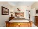 Comfortable main bedroom with light walls, wooden accents, and view into en suite bathroom at 2929 W Yorkshire Dr # 1066, Phoenix, AZ 85027