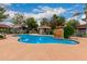 Community pool featuring a rock waterfall feature, covered seating, and pristine blue water for residents to enjoy at 2929 W Yorkshire Dr # 1066, Phoenix, AZ 85027