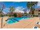 Community swimming pool with spa, lounge chairs, and waterfall feature, perfect for relaxing and unwinding at 2929 W Yorkshire Dr # 1066, Phoenix, AZ 85027