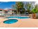 Community swimming pool features a built-in spa, lounge chairs for relaxing, and lush landscaping at 2929 W Yorkshire Dr # 1066, Phoenix, AZ 85027