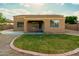 The backyard features desert landscaping, a manicured grassy area, and block wall fencing at 3047 S Chatsworth --, Mesa, AZ 85212