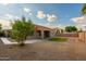 The backyard features desert landscaping with a manicured grassy area, and block wall fencing at 3047 S Chatsworth --, Mesa, AZ 85212