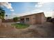 The backyard features desert landscaping, a manicured grassy area, and block wall fencing at 3047 S Chatsworth --, Mesa, AZ 85212