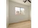 Bright, empty bedroom with wood-look floors, wainscoting and a large window at 3047 S Chatsworth --, Mesa, AZ 85212