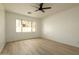 Bright, empty bedroom with wood-look floors and a large window at 3047 S Chatsworth --, Mesa, AZ 85212