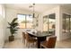 Cozy dining room featuring a modern chandelier, a dark wood table, and large windows at 3047 S Chatsworth --, Mesa, AZ 85212