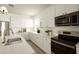Elegant kitchen featuring white cabinetry, sleek countertops, and stainless steel appliances at 3047 S Chatsworth --, Mesa, AZ 85212