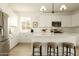 Beautiful open kitchen with stainless appliances, white cabinets, ample counter space, and stylish pendant lighting at 3047 S Chatsworth --, Mesa, AZ 85212