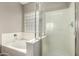 Bright bathroom featuring a bathtub and a glass-enclosed shower, perfect for relaxation and everyday use at 3387 E Bluejay Dr, Chandler, AZ 85286