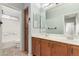 Spacious bathroom features double sinks, wooden cabinets and large mirror at 3387 E Bluejay Dr, Chandler, AZ 85286