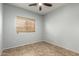 This bedroom offers neutral paint, ceiling fan and tile flooring at 3387 E Bluejay Dr, Chandler, AZ 85286