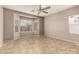 Spacious bedroom with neutral walls, ceiling fan, and large windows providing ample natural light at 3387 E Bluejay Dr, Chandler, AZ 85286
