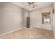 Neutral bedroom with a ceiling fan, tiled floors, a decorative light fixture, and natural light from the window at 3387 E Bluejay Dr, Chandler, AZ 85286