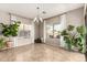 Bright dining room with tiled floors, white curtains, a modern chandelier, and ample natural light at 3387 E Bluejay Dr, Chandler, AZ 85286