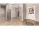 Inviting foyer with neutral walls, decorative floor tile, and an arched entryway into a spacious living area at 3387 E Bluejay Dr, Chandler, AZ 85286