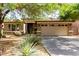 Charming single-story home featuring a two-car garage, desert landscaping, and a covered entryway at 3387 E Bluejay Dr, Chandler, AZ 85286