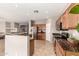 Open kitchen featuring granite countertops, stainless steel appliances, wood cabinetry, and tile flooring at 3387 E Bluejay Dr, Chandler, AZ 85286