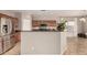 Kitchen with granite countertops, stainless steel refrigerator, ample wood cabinets, and tile flooring at 3387 E Bluejay Dr, Chandler, AZ 85286