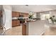 Well-lit kitchen featuring stainless steel appliances, granite countertops, a breakfast bar, and access to the dining area at 3387 E Bluejay Dr, Chandler, AZ 85286