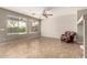 Bright living room with large windows, neutral paint, tile flooring, and a cozy chair at 3387 E Bluejay Dr, Chandler, AZ 85286