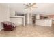 Spacious living area with tile flooring, open to the kitchen, featuring neutral tones and a ceiling fan at 3387 E Bluejay Dr, Chandler, AZ 85286