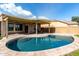 Backyard featuring a pristine pool area with a covered patio for shaded lounging at 3387 E Bluejay Dr, Chandler, AZ 85286