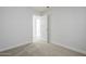 A well-lit bedroom with carpeted floors and an open doorway to another room at 340 W Riviera Dr, Tempe, AZ 85282