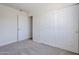 Bright bedroom features carpeted floors, a closet, and a connecting door at 340 W Riviera Dr, Tempe, AZ 85282