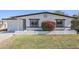 Charming home with fresh white paint, black trim, and a vibrant flowering bush at 340 W Riviera Dr, Tempe, AZ 85282