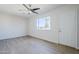 Bright living room with wood-look floors, ceiling fan, and view to palm trees at 340 W Riviera Dr, Tempe, AZ 85282