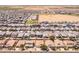 Aerial shot of a spacious neighborhood features landscaped yards, tree-lined streets, and a tranquil desert backdrop at 36197 W Cartegna Ln, Maricopa, AZ 85138